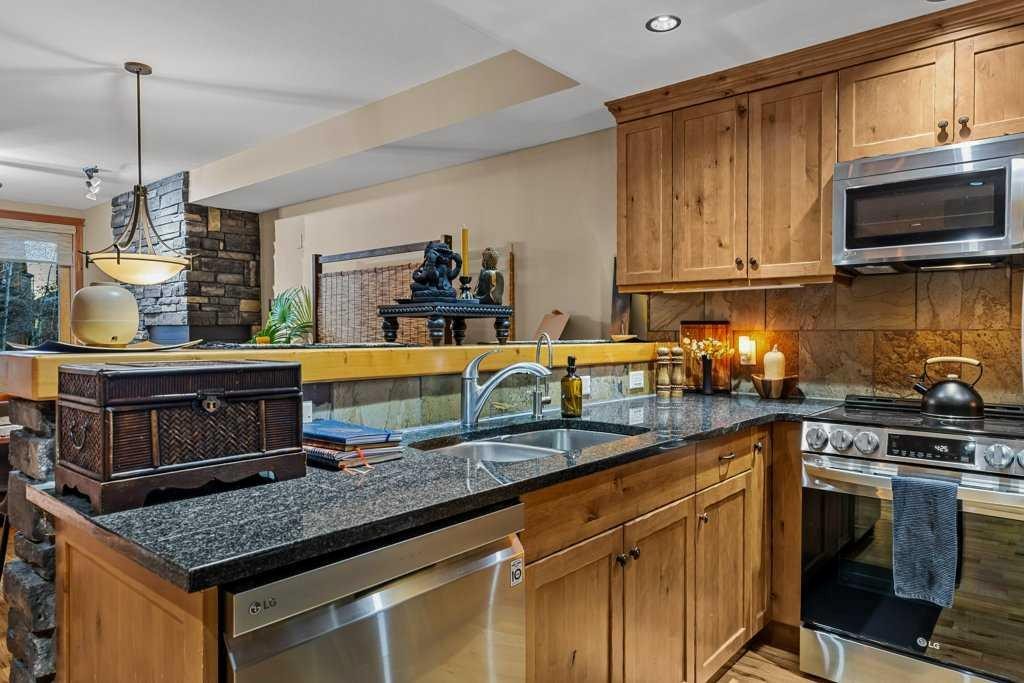 2107-101B Stewart Creek Landing, Canmore, AB - Indoor Photo Showing Kitchen With Double Sink