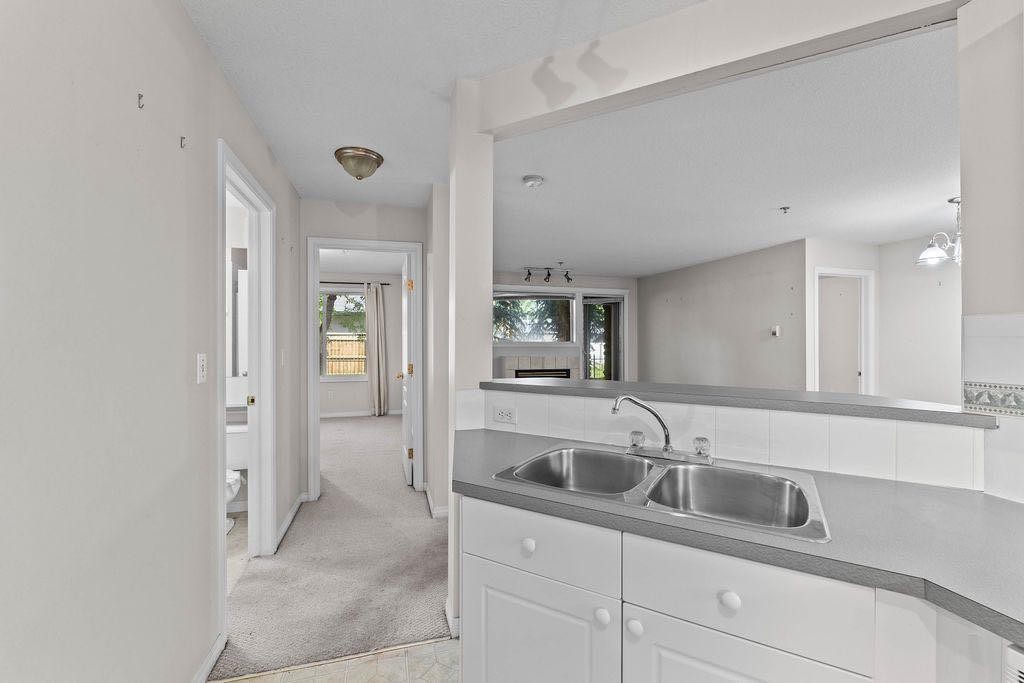 109-4507 45 Street Sw, Calgary, AB - Indoor Photo Showing Kitchen With Double Sink