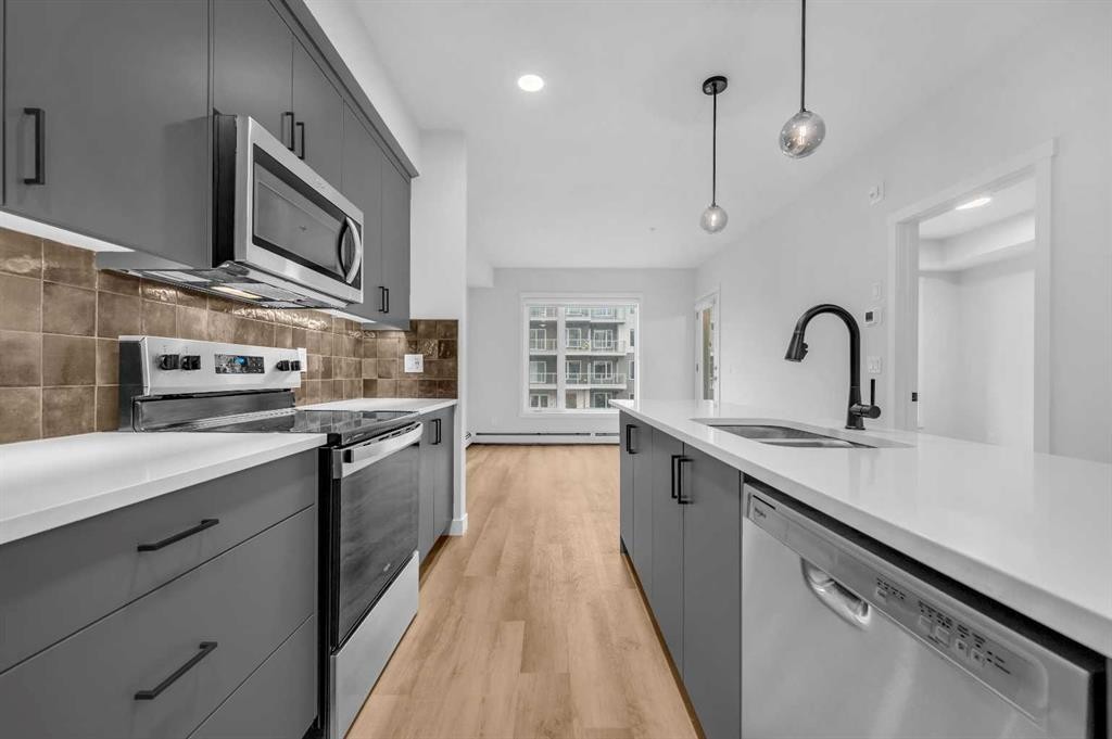 212-660 Shawnee Square Sw, Calgary, AB - Indoor Photo Showing Kitchen With Double Sink With Upgraded Kitchen