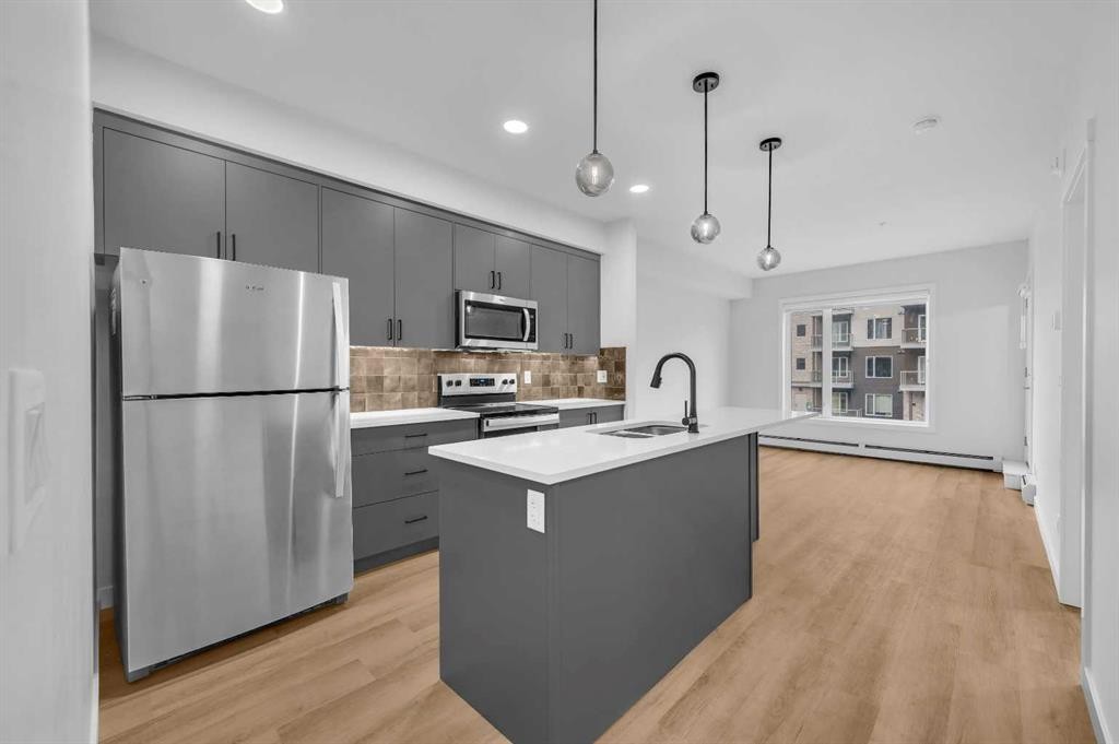 212-660 Shawnee Square Sw, Calgary, AB - Indoor Photo Showing Kitchen With Stainless Steel Kitchen With Upgraded Kitchen