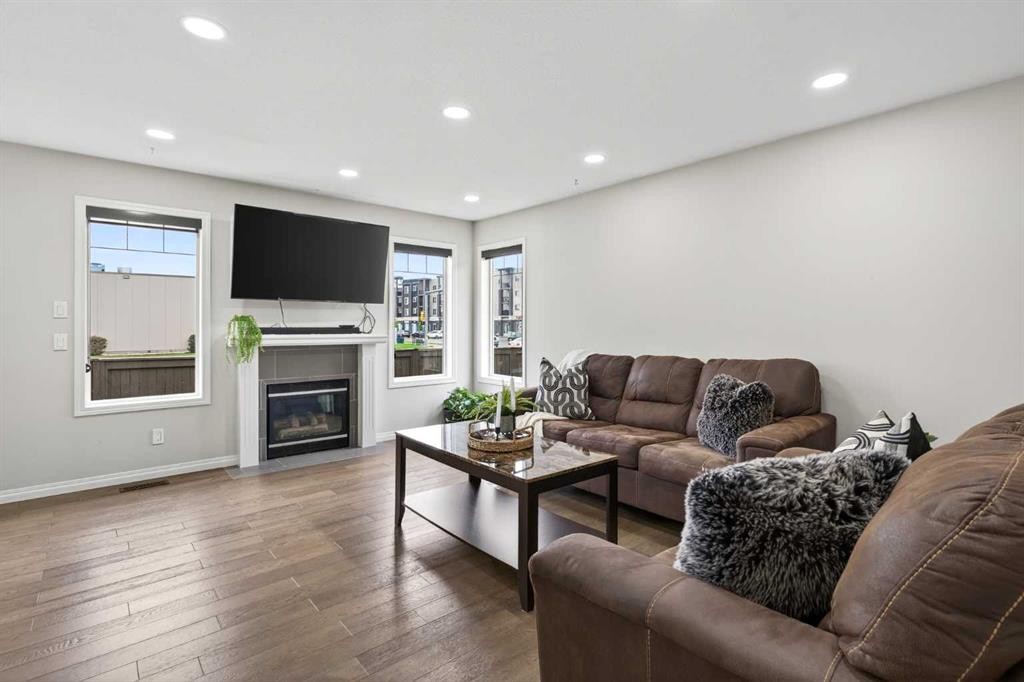 21-102 Canoe Square Sw, Airdrie, AB - Indoor Photo Showing Living Room With Fireplace