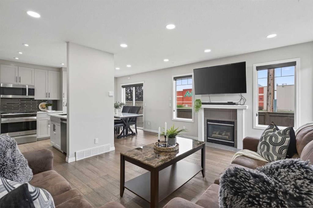 21-102 Canoe Square Sw, Airdrie, AB - Indoor Photo Showing Living Room With Fireplace