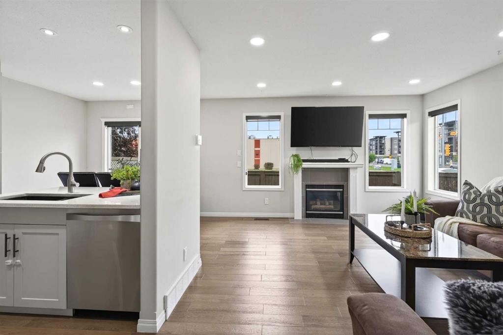 21-102 Canoe Square Sw, Airdrie, AB - Indoor Photo Showing Living Room With Fireplace