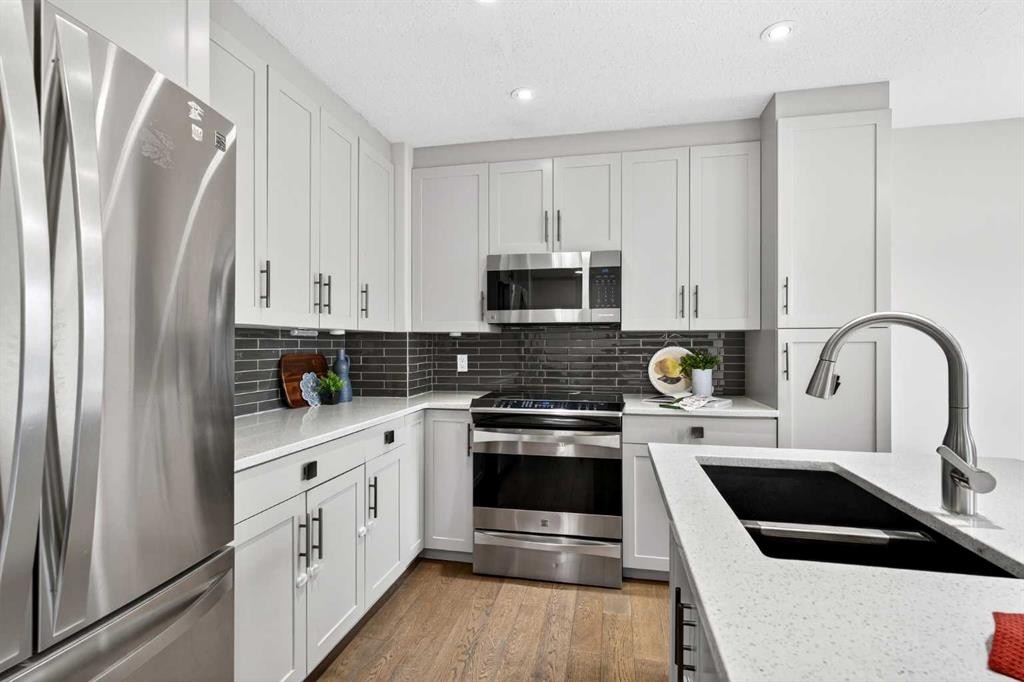 21-102 Canoe Square Sw, Airdrie, AB - Indoor Photo Showing Kitchen With Stainless Steel Kitchen With Double Sink With Upgraded Kitchen