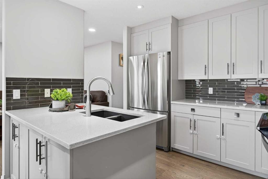 21-102 Canoe Square Sw, Airdrie, AB - Indoor Photo Showing Kitchen With Stainless Steel Kitchen With Double Sink With Upgraded Kitchen