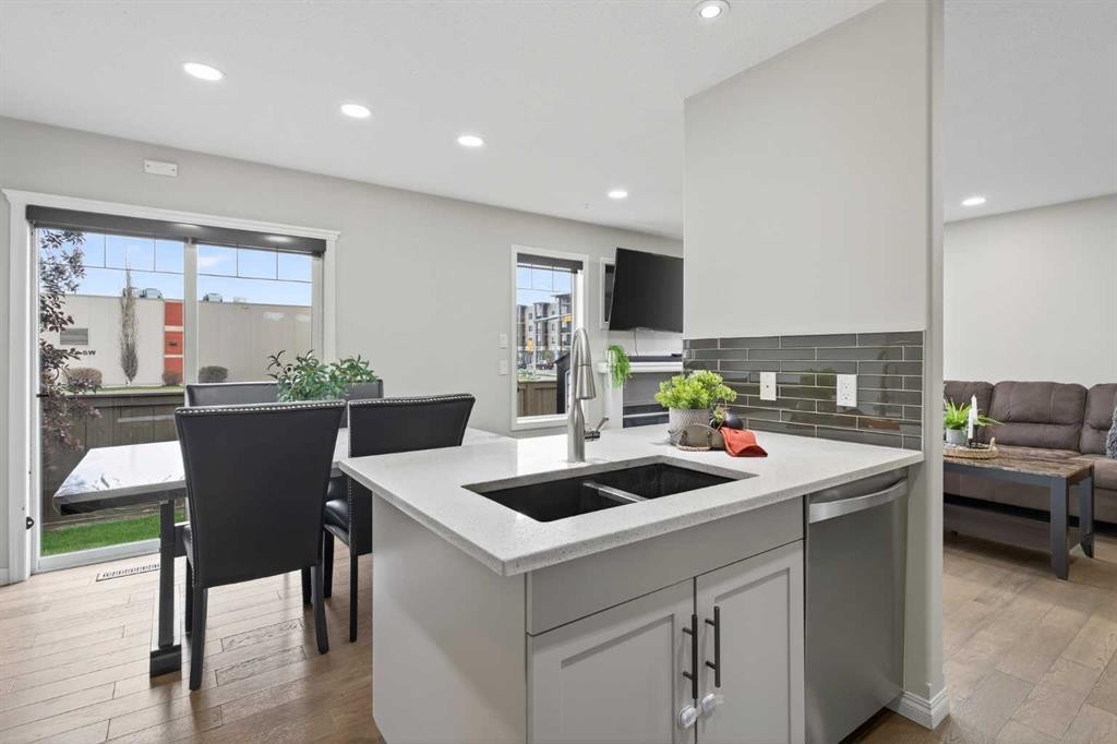 21-102 Canoe Square Sw, Airdrie, AB - Indoor Photo Showing Kitchen With Double Sink