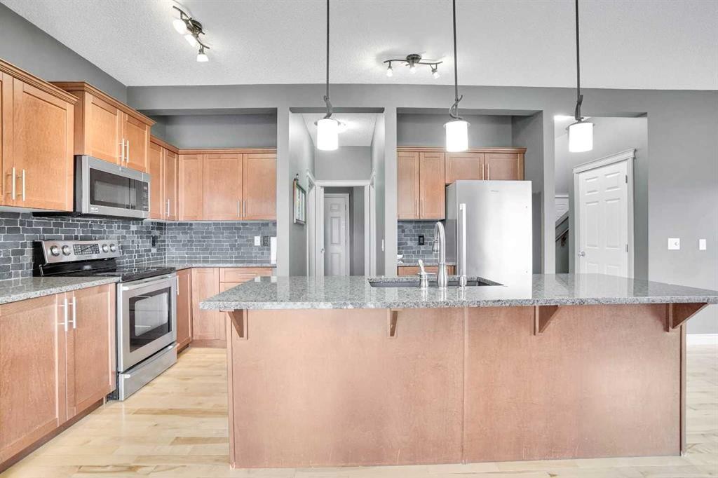 208 Sagewood Landing Sw, Airdrie, AB - Indoor Photo Showing Kitchen With Upgraded Kitchen