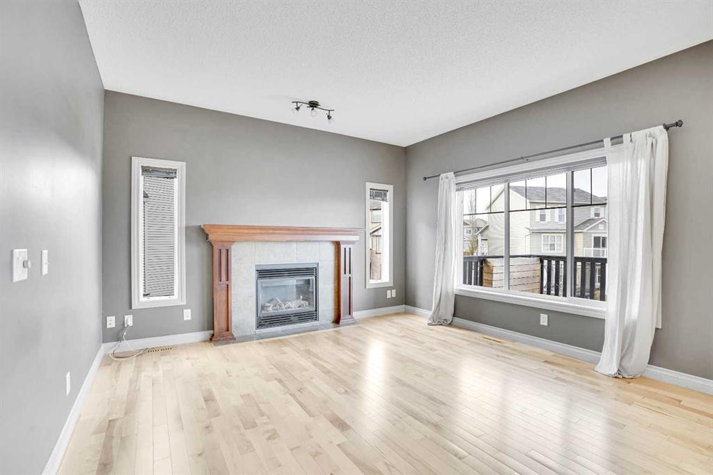 208 Sagewood Landing Sw, Airdrie, AB - Indoor Photo Showing Living Room With Fireplace