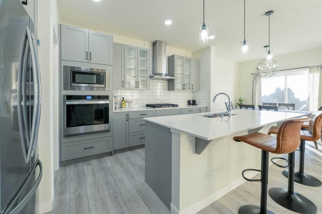 15 Midgrove Drive Sw, Airdrie, AB - Indoor Photo Showing Kitchen With Stainless Steel Kitchen With Double Sink With Upgraded Kitchen