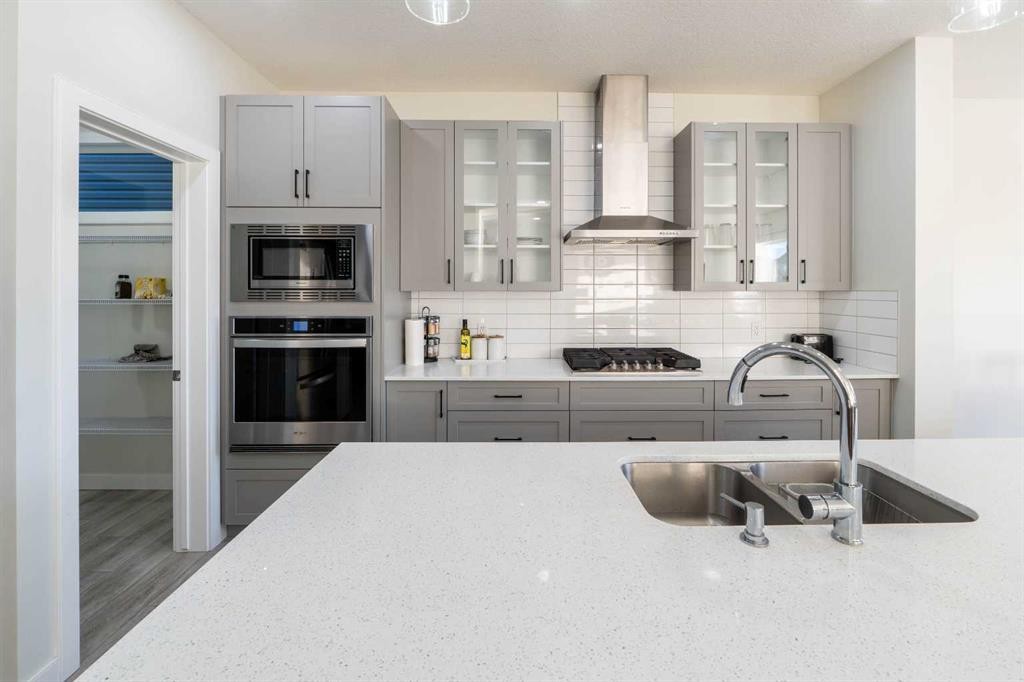 15 Midgrove Drive Sw, Airdrie, AB - Indoor Photo Showing Kitchen With Double Sink With Upgraded Kitchen