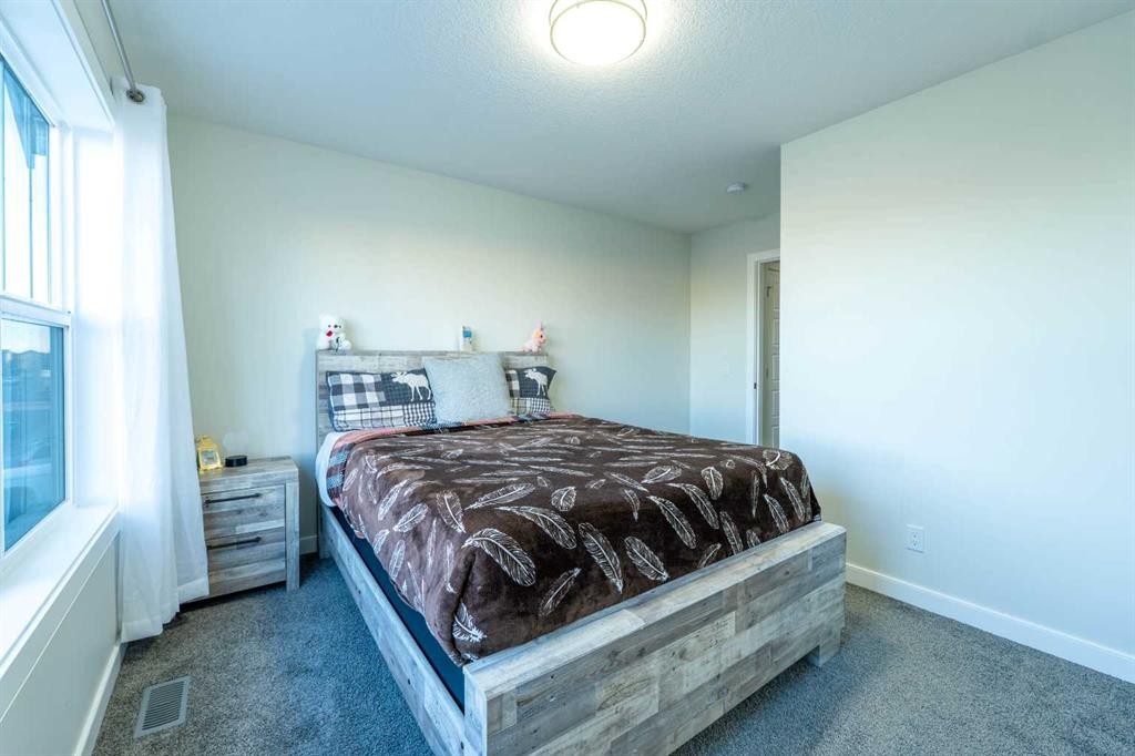 15 Midgrove Drive Sw, Airdrie, AB - Indoor Photo Showing Bedroom