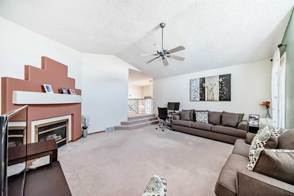 41 Covette Bay Ne, Calgary, AB - Indoor Photo Showing Living Room With Fireplace