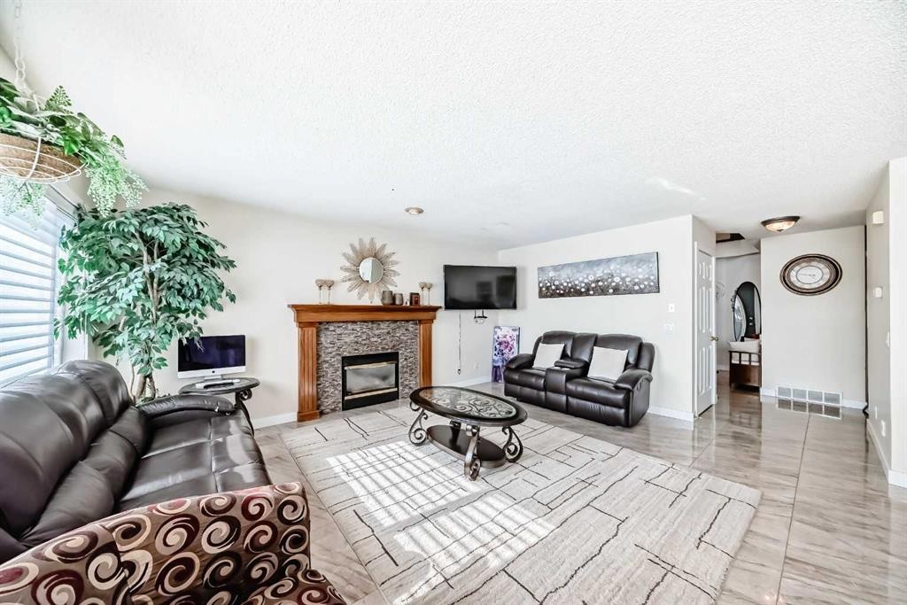 41 Covette Bay Ne, Calgary, AB - Indoor Photo Showing Living Room With Fireplace