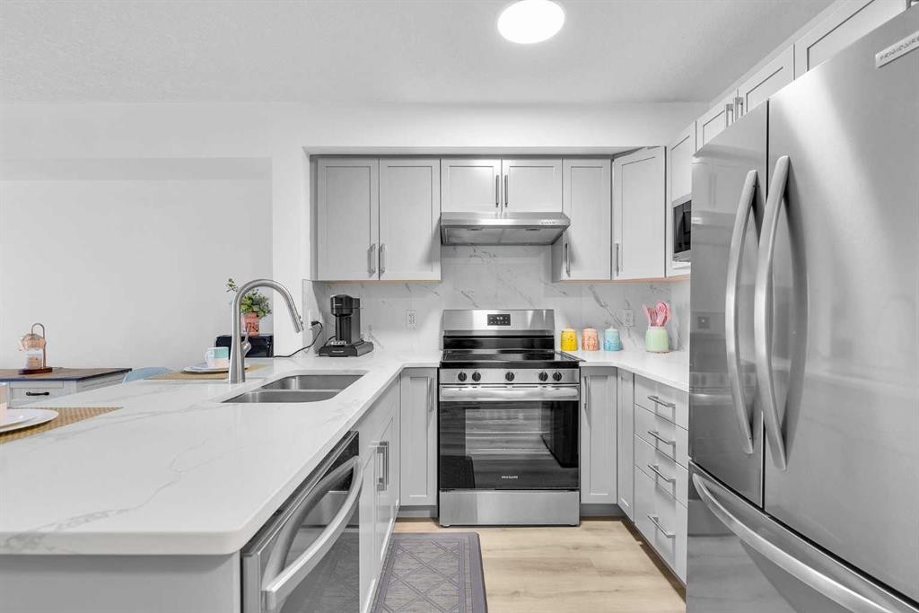 2214-175 Panatella Hill Nw, Calgary, AB - Indoor Photo Showing Kitchen With Stainless Steel Kitchen With Double Sink