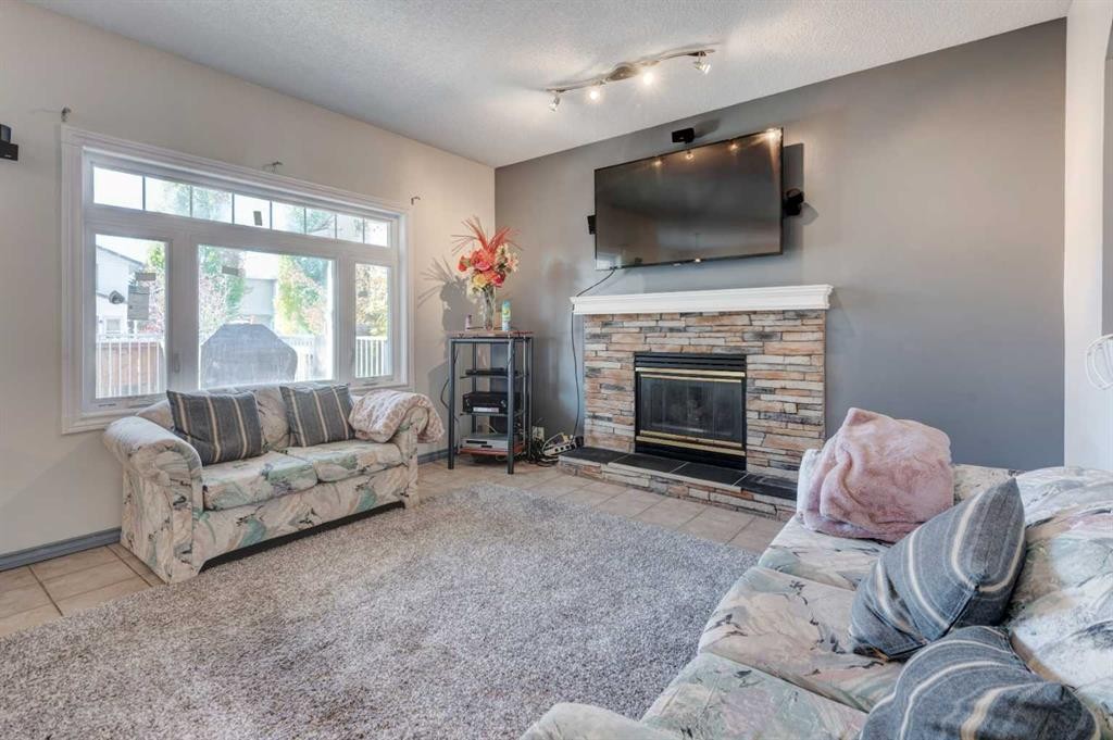 414 Mt Cornwall Circle Se, Calgary, AB - Indoor Photo Showing Living Room With Fireplace