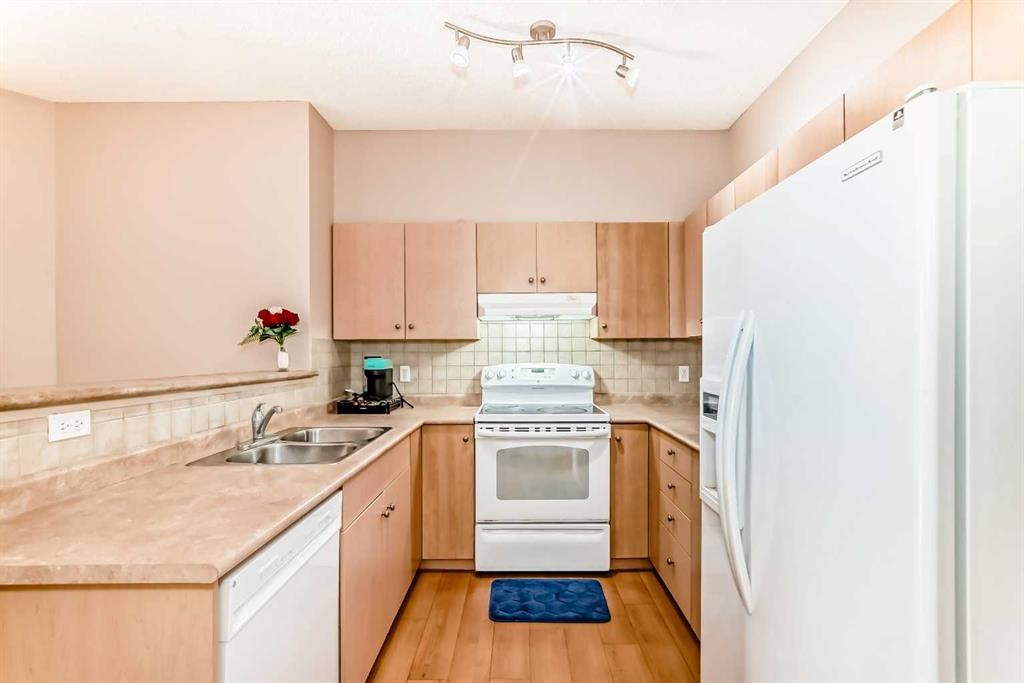 2115-1140 Taradale Drive Ne, Calgary, AB - Indoor Photo Showing Kitchen With Double Sink