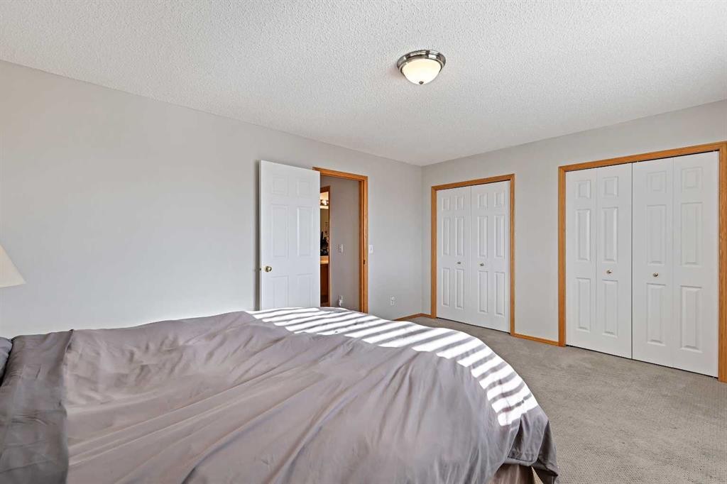 258 Rocky Ridge Court Nw, Calgary, AB - Indoor Photo Showing Bedroom