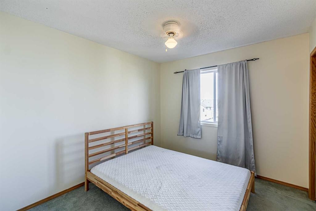 49 Welshimer Crescent Ne, Langdon, AB - Indoor Photo Showing Bedroom