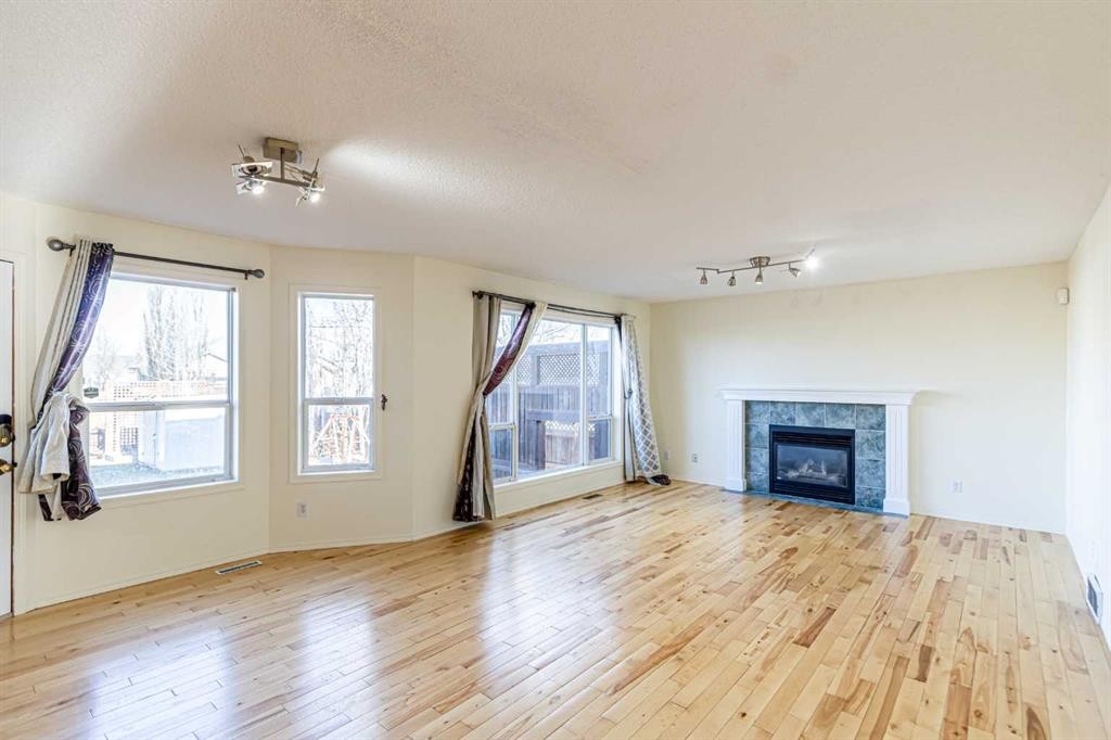 49 Welshimer Crescent Ne, Langdon, AB - Indoor Photo Showing Living Room With Fireplace