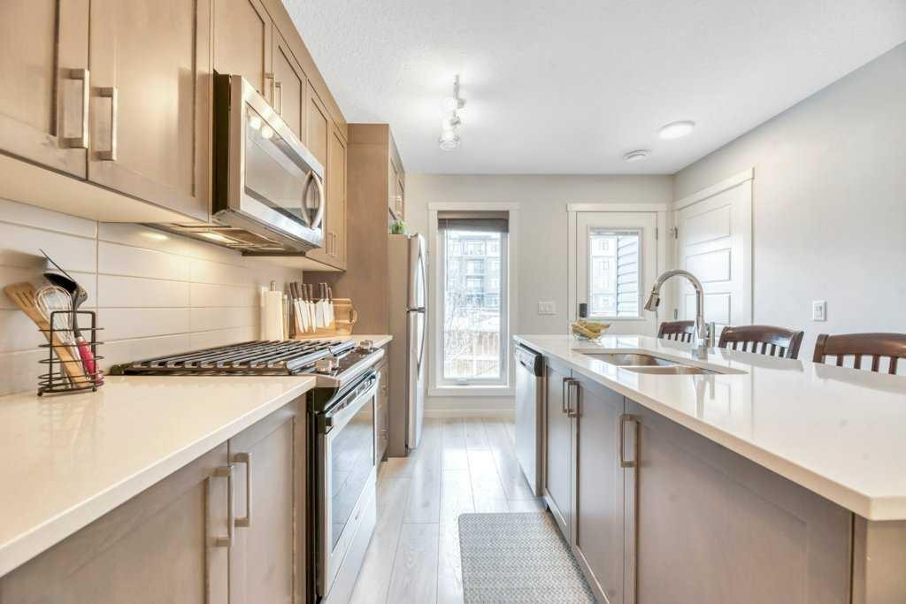 413-338 Seton Circle Se, Calgary, AB - Indoor Photo Showing Kitchen With Double Sink With Upgraded Kitchen
