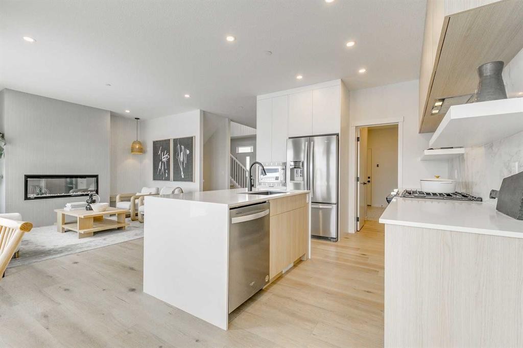 227 Lucas Common Nw, Calgary, AB - Indoor Photo Showing Kitchen With Fireplace