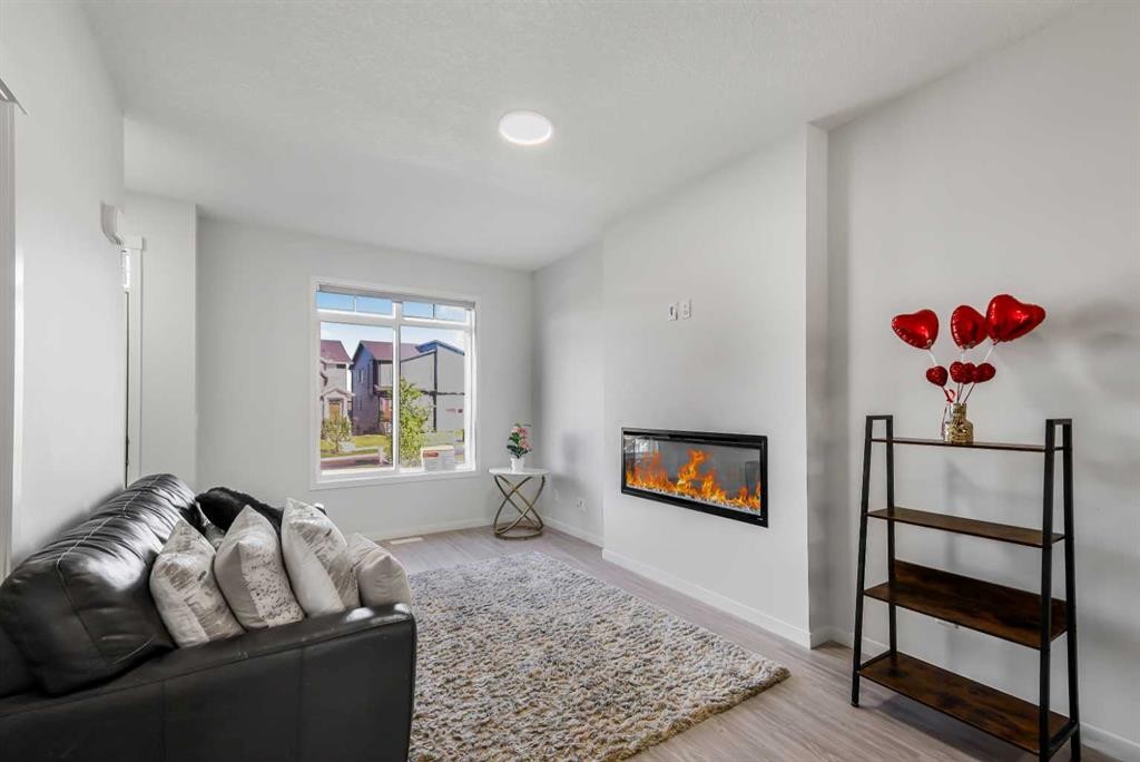 15 Edith Passage Nw, Calgary, AB - Indoor Photo Showing Living Room With Fireplace