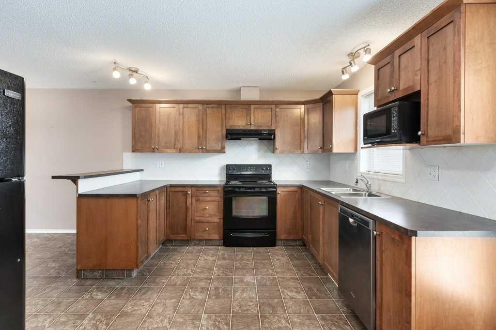 1102 Prairie Sound Circle Nw, High River, AB - Indoor Photo Showing Kitchen With Double Sink