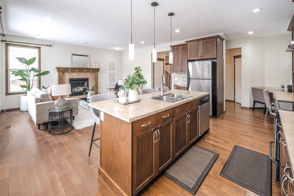 164 Everbrook Drive Sw, Calgary, AB - Indoor Photo Showing Kitchen With Fireplace With Stainless Steel Kitchen With Double Sink With Upgraded Kitchen