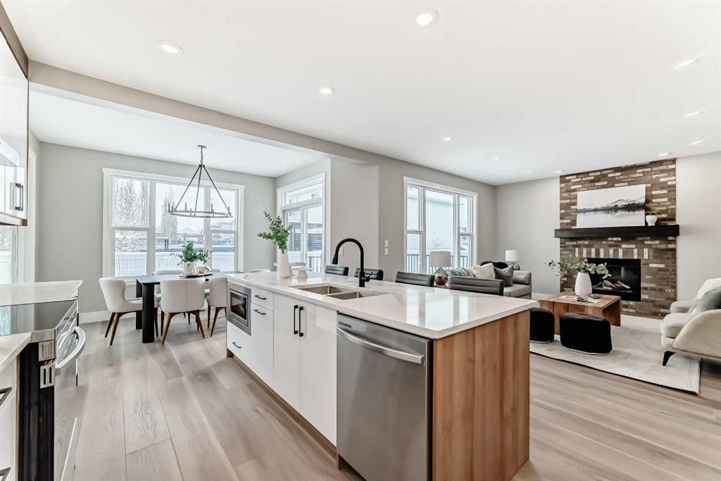 101 Auburn Springs Park Se, Calgary, AB - Indoor Photo Showing Kitchen With Fireplace With Double Sink With Upgraded Kitchen