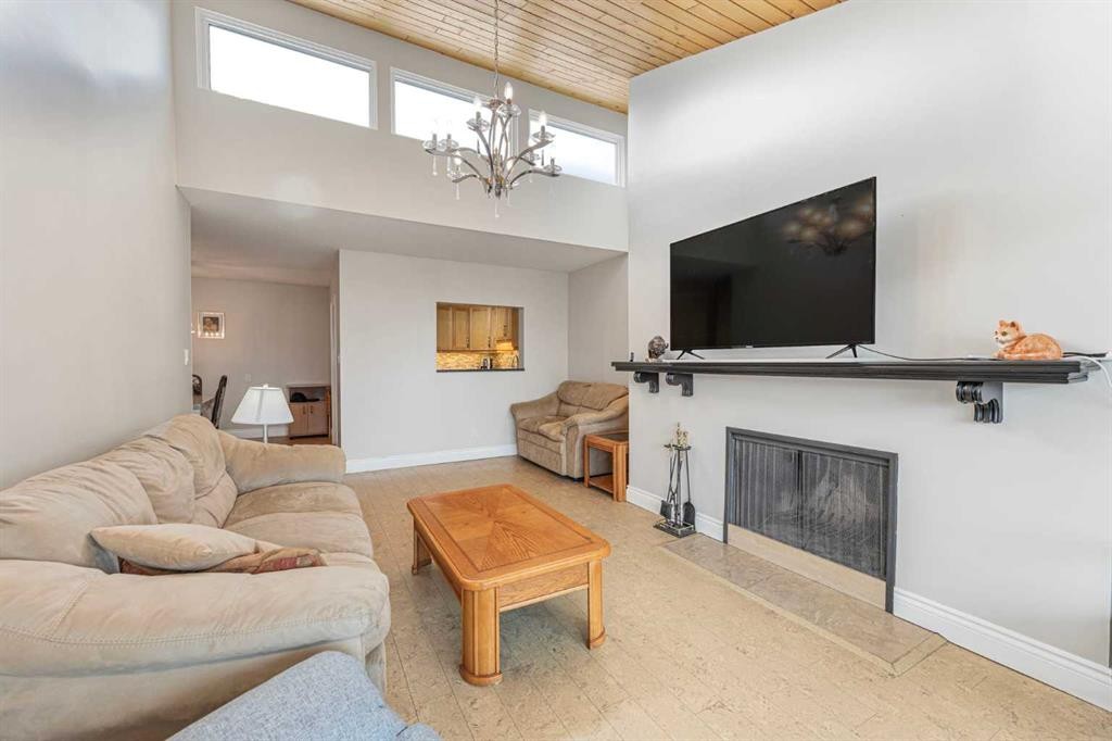 410-3730 50 Street Nw, Calgary, AB - Indoor Photo Showing Living Room With Fireplace