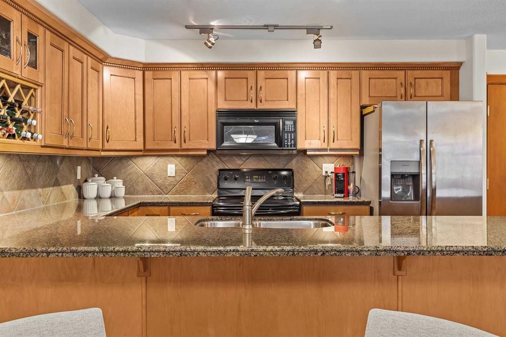 112-150 Crosbow Place, Canmore, AB - Indoor Photo Showing Kitchen With Double Sink