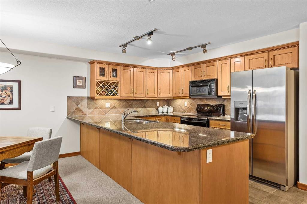 112-150 Crosbow Place, Canmore, AB - Indoor Photo Showing Kitchen With Double Sink