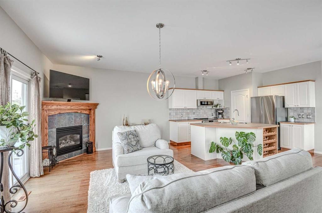 96 Hampstead Green Nw, Calgary, AB - Indoor Photo Showing Living Room With Fireplace