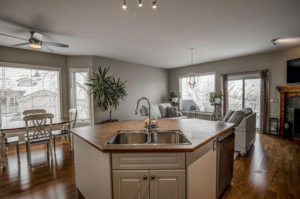 96 Hampstead Green Nw, Calgary, AB - Indoor Photo Showing Kitchen With Fireplace With Double Sink