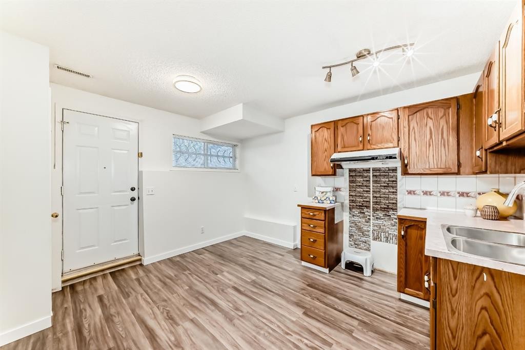 34 Erin Meadow Close Se, Calgary, AB - Indoor Photo Showing Kitchen With Double Sink