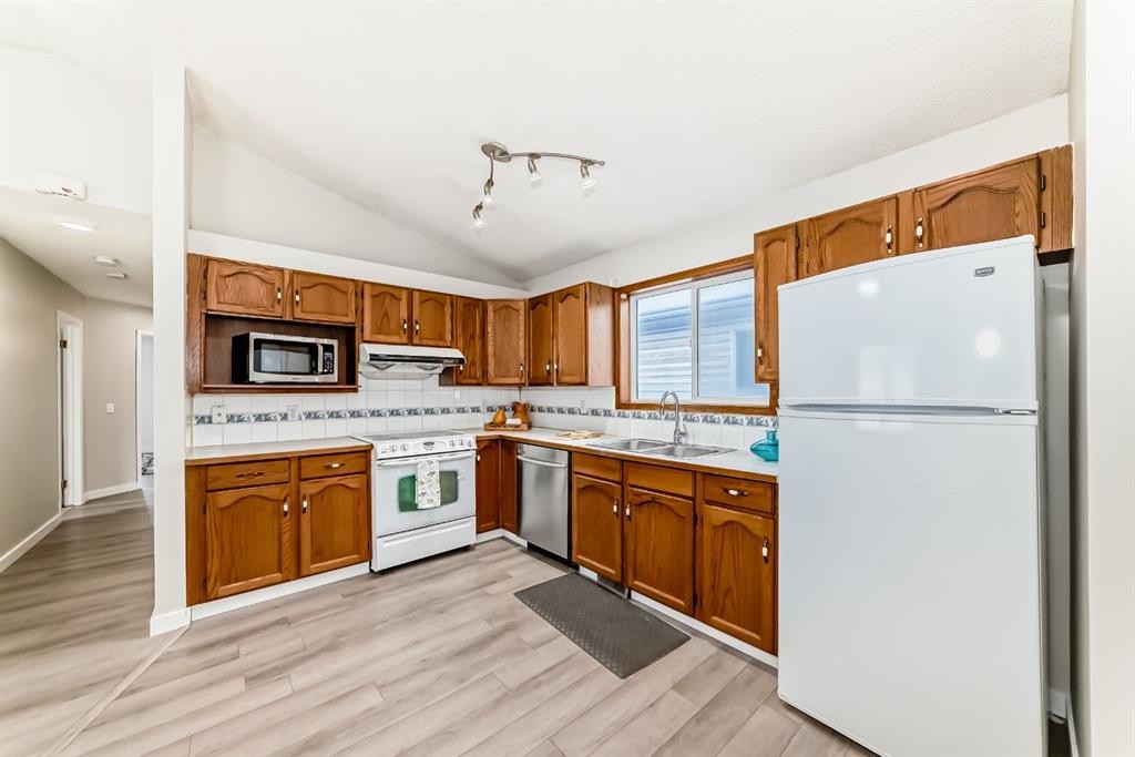 34 Erin Meadow Close Se, Calgary, AB - Indoor Photo Showing Kitchen With Double Sink