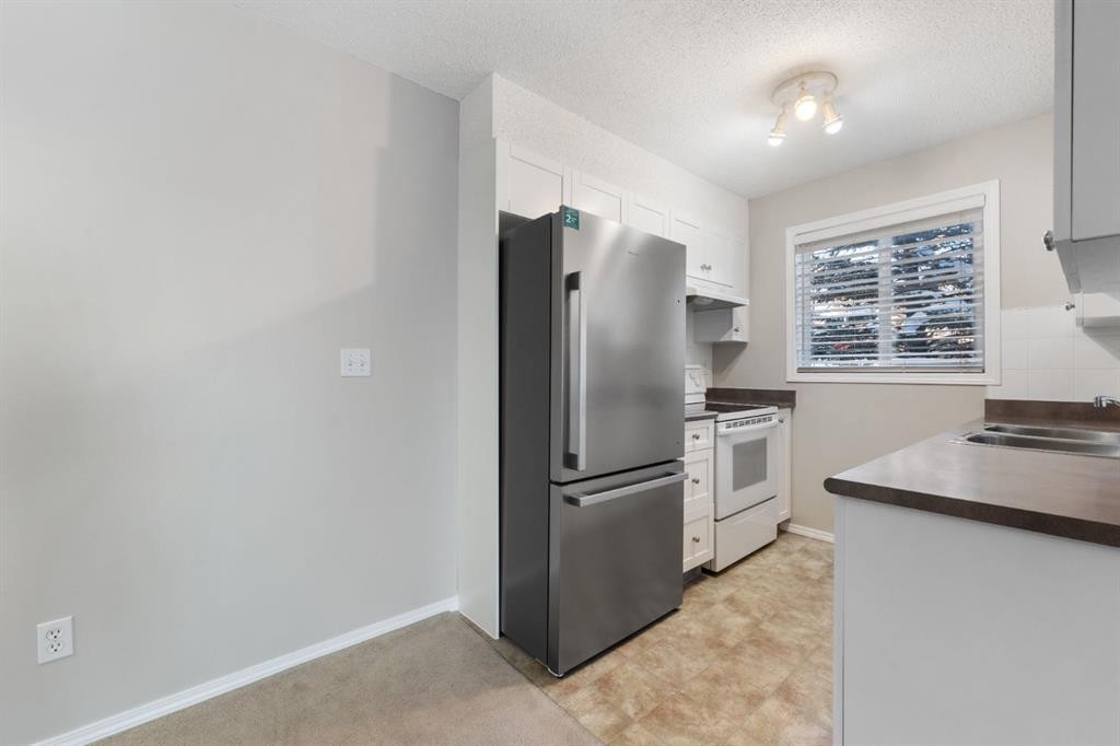 1102-2395 Eversyde Avenue Sw, Calgary, AB - Indoor Photo Showing Kitchen With Double Sink