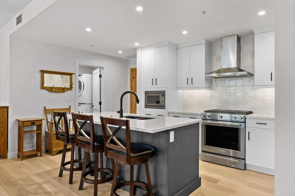 107-1315 Spring Creek Gate, Canmore, AB - Indoor Photo Showing Kitchen With Stainless Steel Kitchen With Upgraded Kitchen