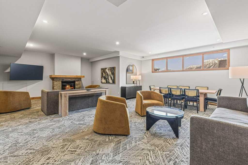 107-1315 Spring Creek Gate, Canmore, AB - Indoor Photo Showing Living Room With Fireplace