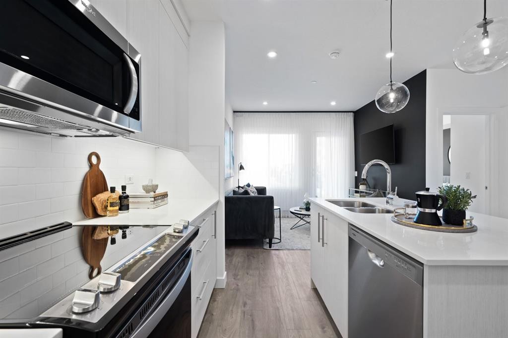 2210-6 Merganser Drive West, Chestermere, AB - Indoor Photo Showing Kitchen With Stainless Steel Kitchen With Double Sink With Upgraded Kitchen