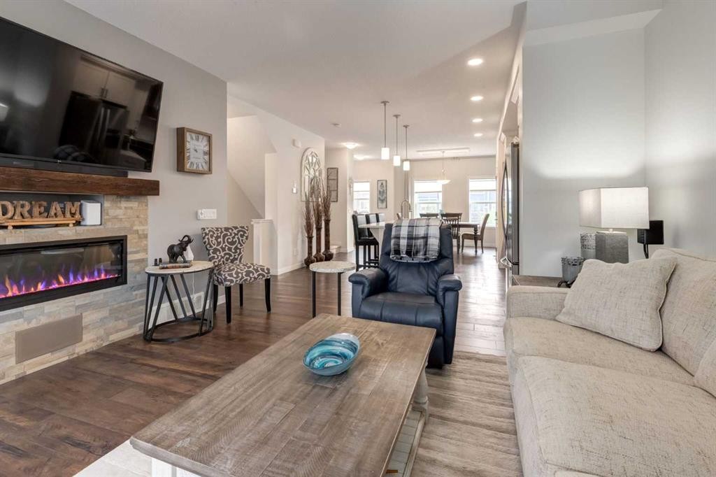 165 Sundown Road, Cochrane, AB - Indoor Photo Showing Living Room With Fireplace