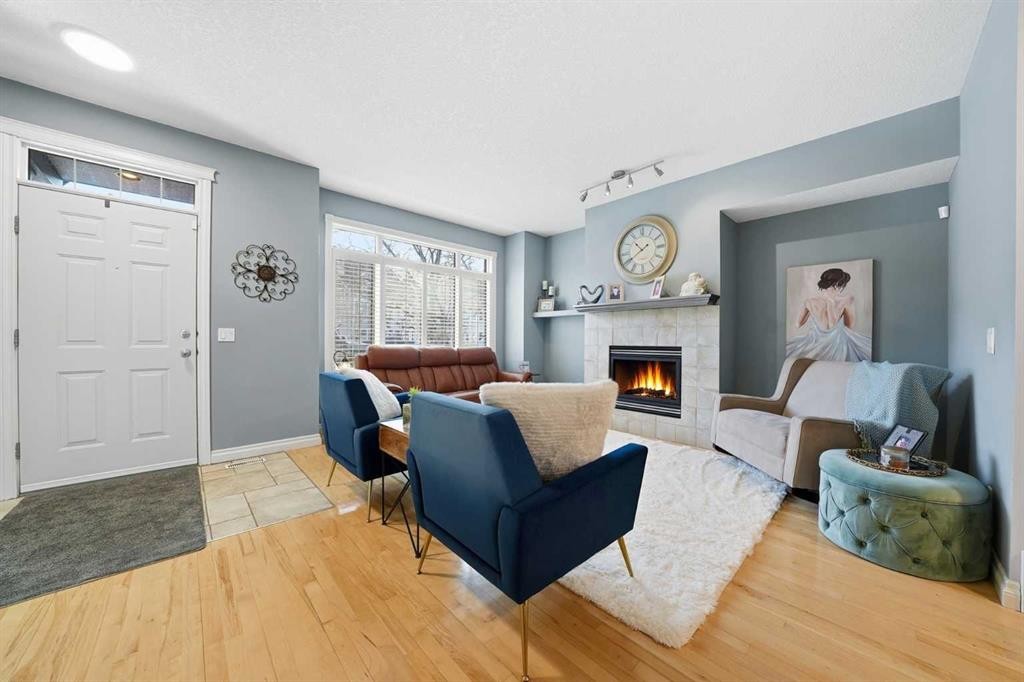 45 Somme Boulevard Sw, Calgary, AB - Indoor Photo Showing Living Room With Fireplace