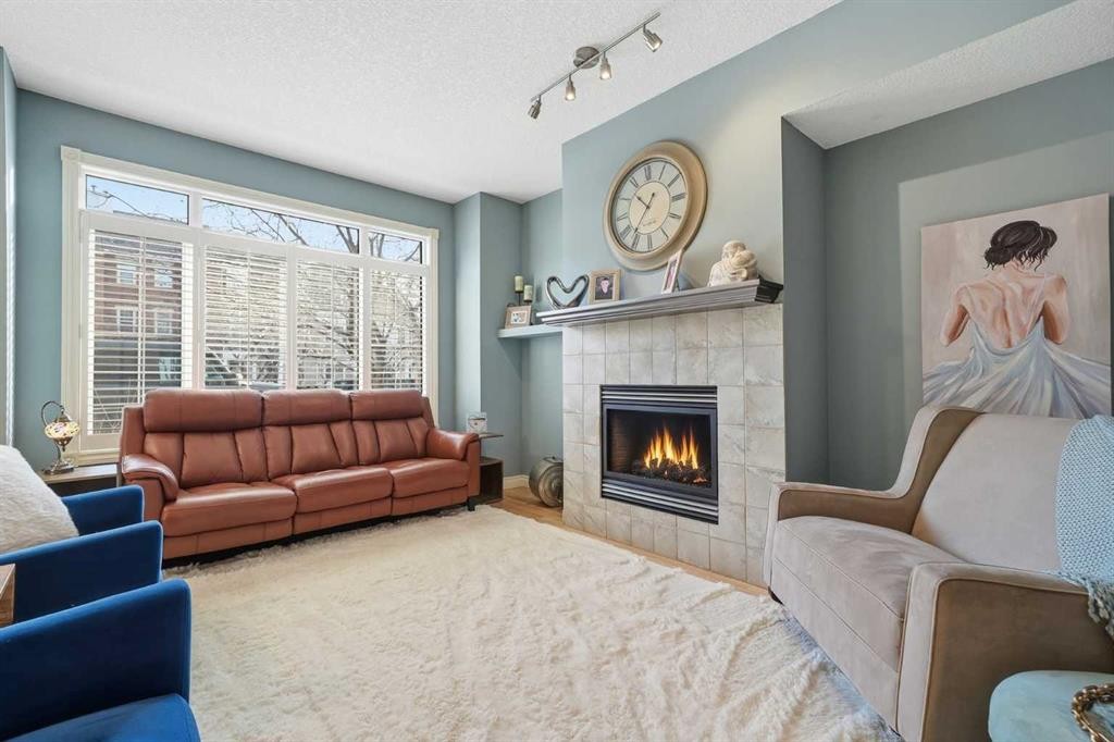 45 Somme Boulevard Sw, Calgary, AB - Indoor Photo Showing Living Room With Fireplace