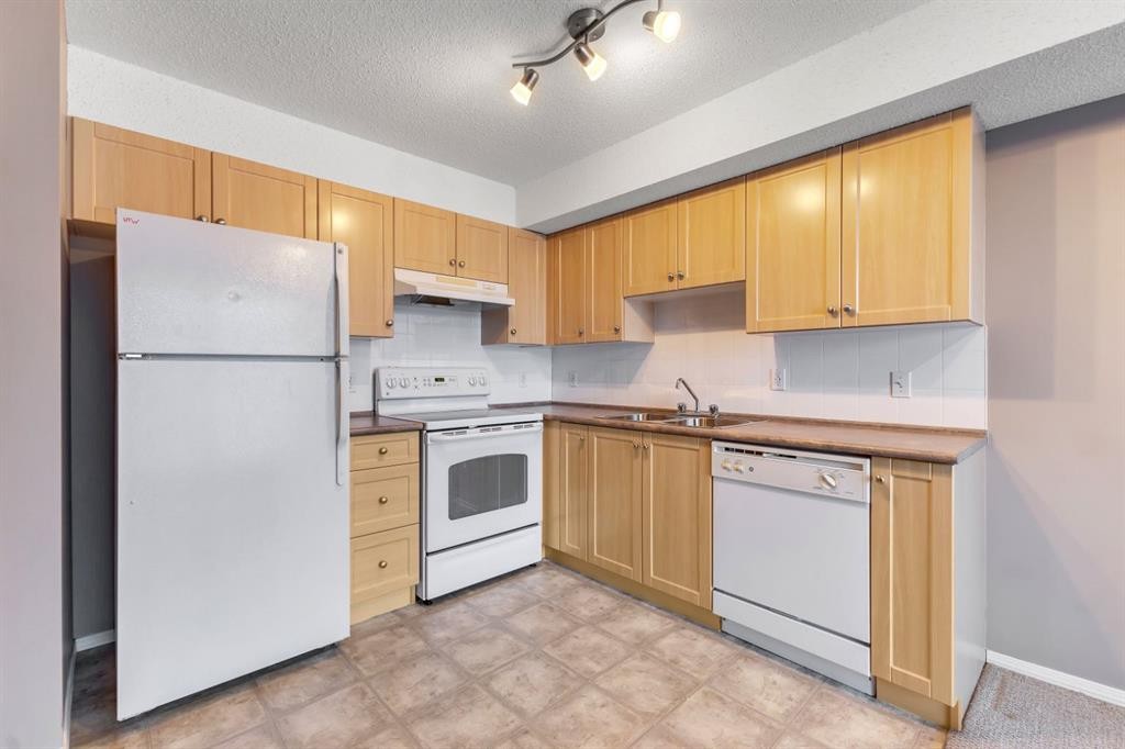 1109-505 Railway Street West, Cochrane, AB - Indoor Photo Showing Kitchen With Double Sink