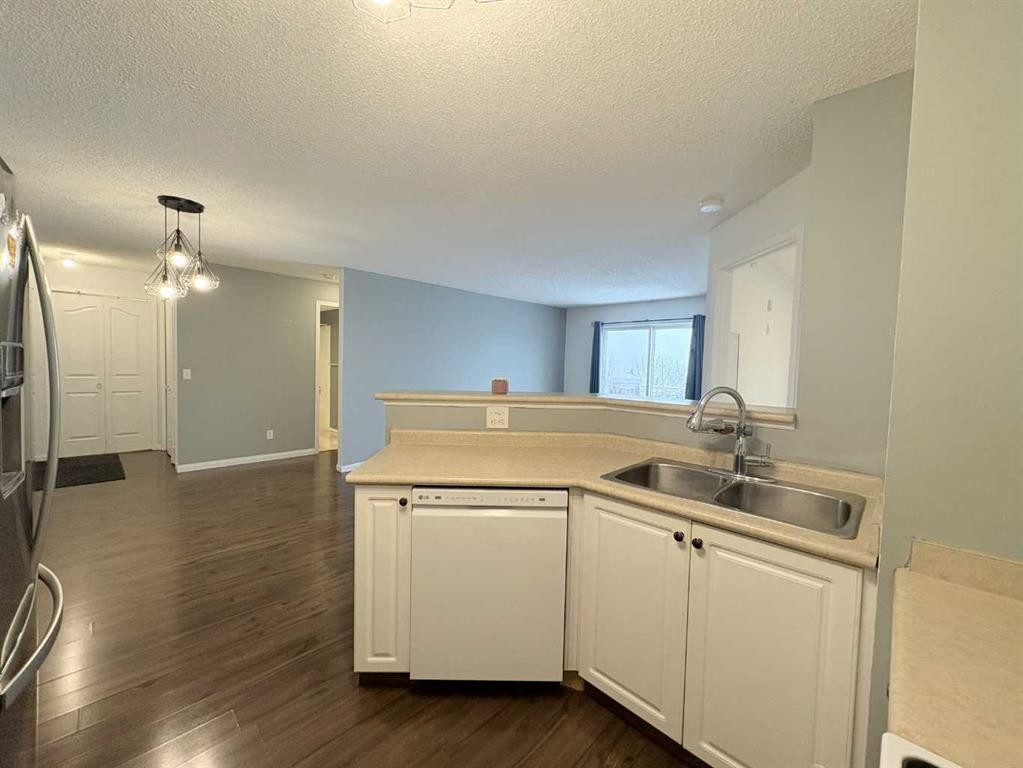 #418-4000 Somervale Court Sw, Calgary, AB - Indoor Photo Showing Kitchen With Double Sink