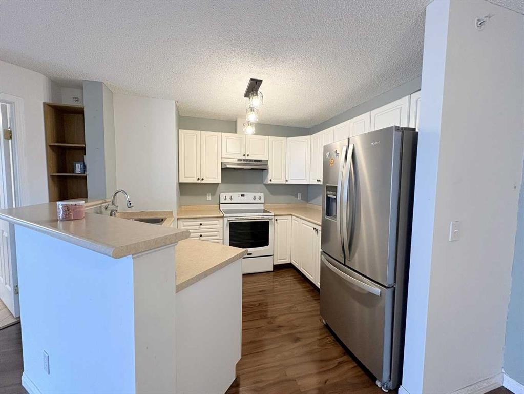 #418-4000 Somervale Court Sw, Calgary, AB - Indoor Photo Showing Kitchen With Double Sink