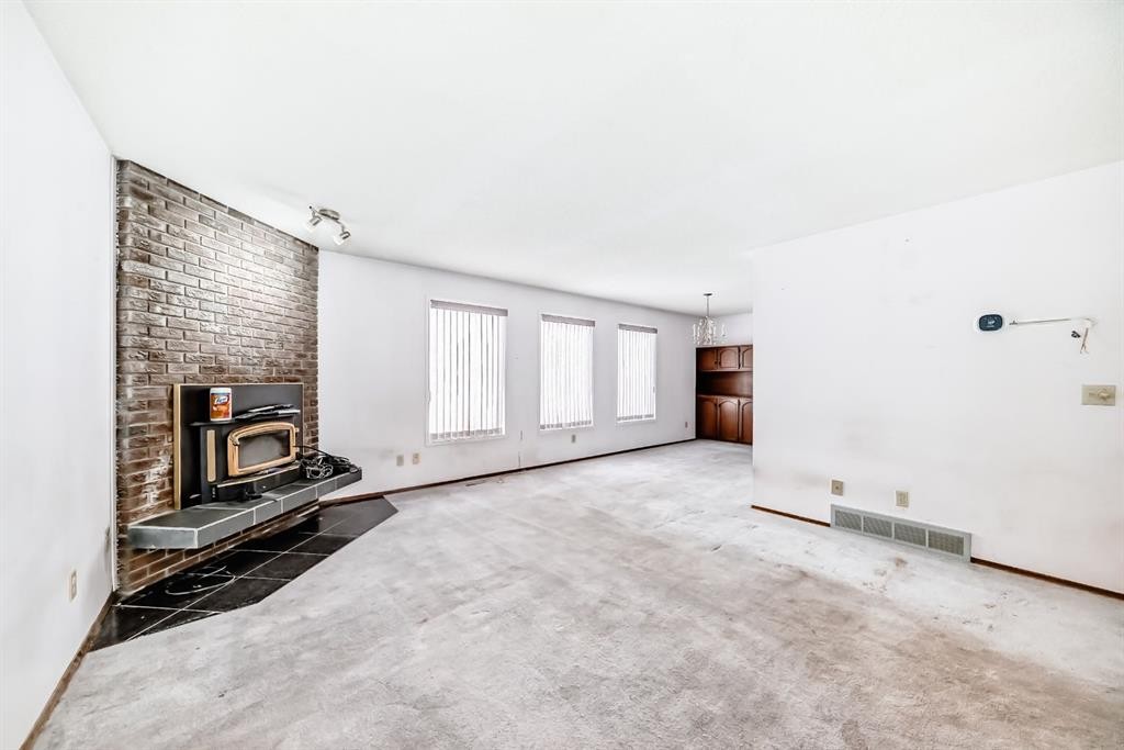 11 Falwood Place Ne, Calgary, AB - Indoor Photo Showing Other Room With Fireplace