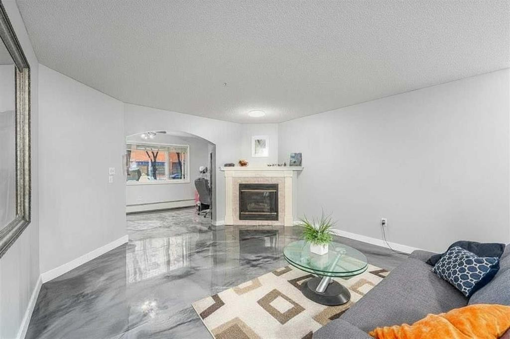 109-777 3 Avenue Sw, Calgary, AB - Indoor Photo Showing Living Room With Fireplace