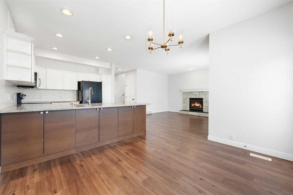 283 Prestwick Landing Se, Calgary, AB - Indoor Photo Showing Kitchen With Fireplace