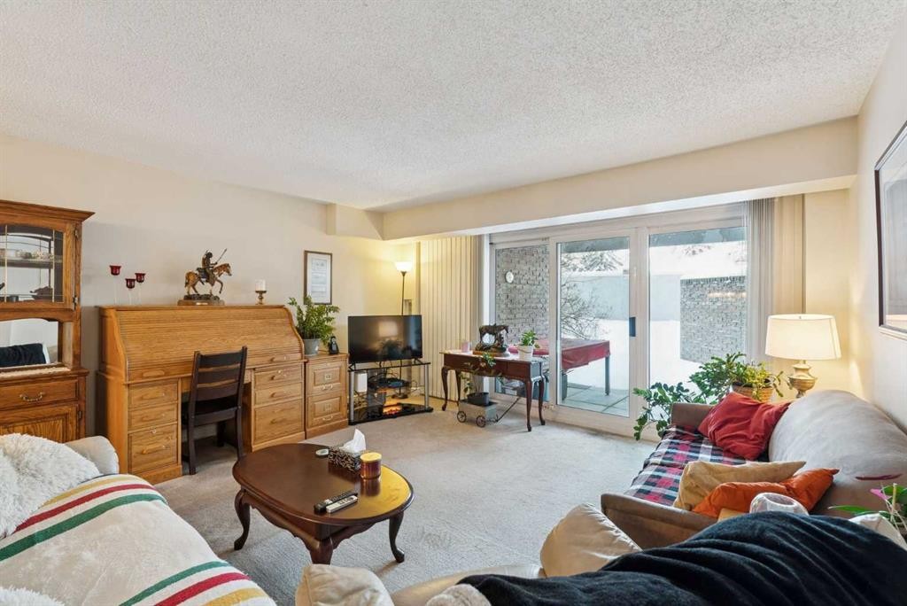 1107-201 Brae Glen Sw, Calgary, AB - Indoor Photo Showing Living Room With Fireplace